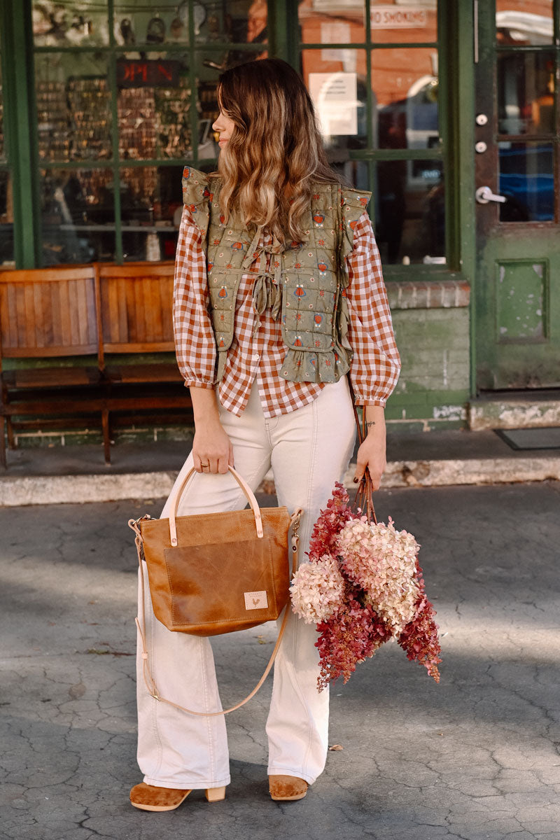 Woman holding camel leather small tote