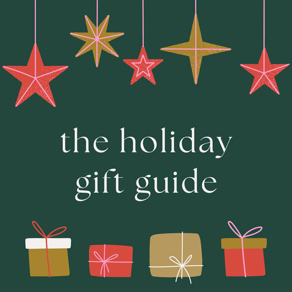 Dark green Christmas banner with star ornaments and Christmas presents displayed. Advertisement reads "the holiday gift guide" 