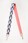 Pink with green and blue design webbing crossbody strap with a cream end color folded in half 