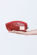 Picture of hand holding a small red leather zipper bag