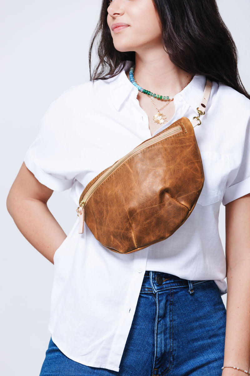 woman with brown leather fanny bag