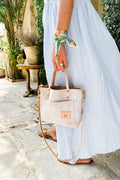 Girl wearing a dress holding a white birch leather small purse 