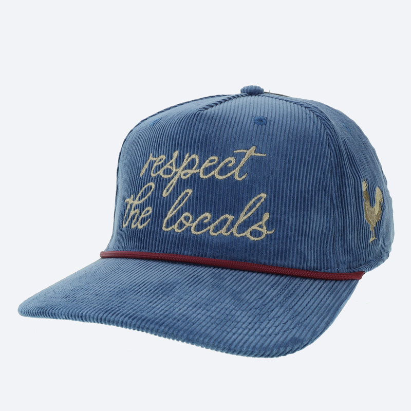 A blue trucker hat that says 'respect the locals' in beige letters