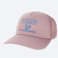 A pink trucker hat that says coastal cowboy in light blue letters with the logo of a rooster on a surfboard